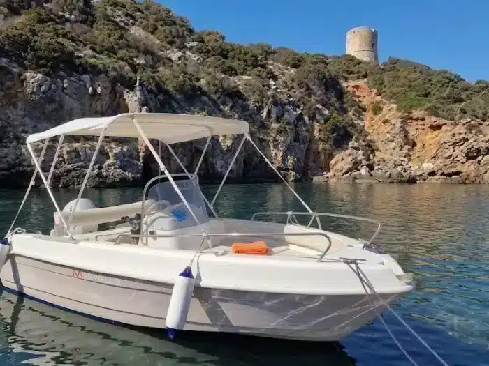 Marinello boat at sea, Alghero coast and Aragonese towers