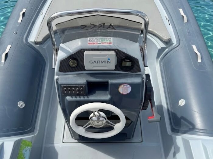 Detail of the steering wheel and controls of the Alghero RIB for rental without a license